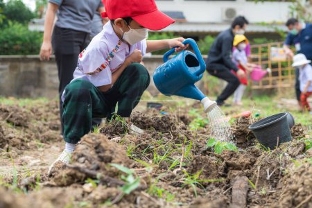 Photo for Kindergarten boy plantation seed on soil outdoor activity happy boy nature learnning - Royalty Free Image
