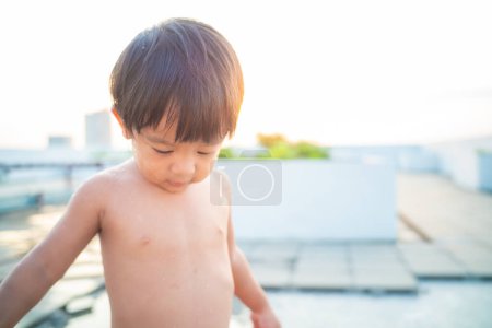 Photo for Little preschool happy boy take shower outdoor in basin toddler boy - Royalty Free Image