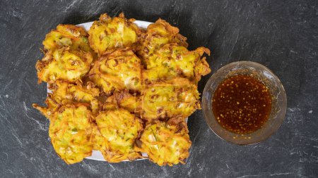 Foto de Bakwan is a fried food made from vegetables and flour that is commonly found in Indonesia. Served with chili or hot chili sauce - Imagen libre de derechos