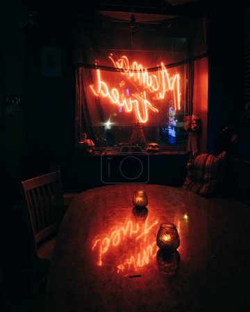 Photo for Mama Tried neon sign reflecting on a table, Brooklyn, New York - Royalty Free Image