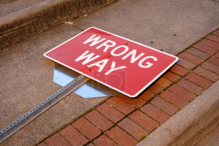 Wrong Way sign laying on the sidewalk in Marion, Virginia