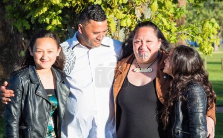 Portrait of a young Maori family taken outdoors