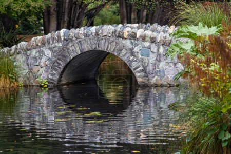 A Stone Arch Footbridge in the Queenstown Botanical Gardens, New Zealand. 