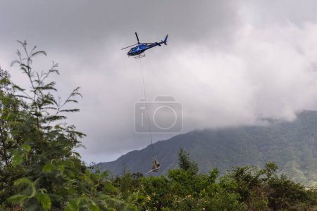 Photo for Reunion Island - Helicopter winching goods to Mafate cirque - Royalty Free Image