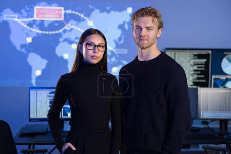 Professional and confident cyber security team SOC in front of cybersecurity SIEM system with logs and incident map. Analyst and security officer CISO