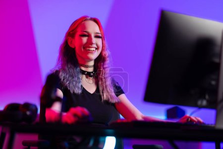 In a vividly colorful gaming room, a concentrated and smiling professional gamer is immersed in an intense gameplay moment, showcasing the vibrant esports environment.