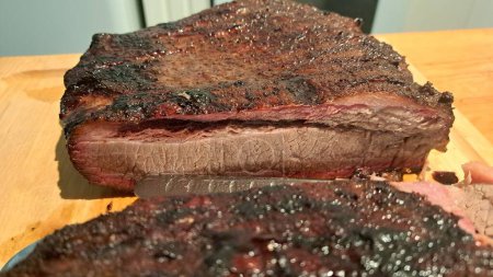 Beef brisket smoked on a charcoal or pellet smoker, sliced
