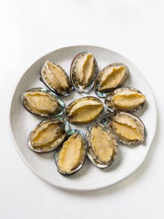 Photo for Delicious raw abalone in a plate on white table background. - Royalty Free Image