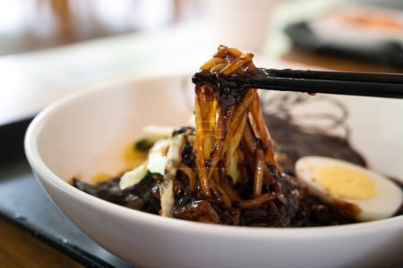 Photo for Delicious Jajangmyeon, jjajangmyeon, fried sauce noodle, Korean-style Chinese noodle dish topped with thick black bean paste sauce in south korea. - Royalty Free Image