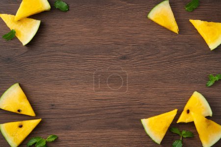 Photo for Sliced yellow golden watermelon pattern flat lay on wooden table background. - Royalty Free Image