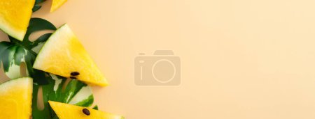 Photo for Sliced yellow golden watermelon with leaves flat lay on pastel yellow table background. - Royalty Free Image