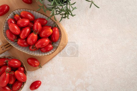 Top view of fresh cherry tomatoes over white table background