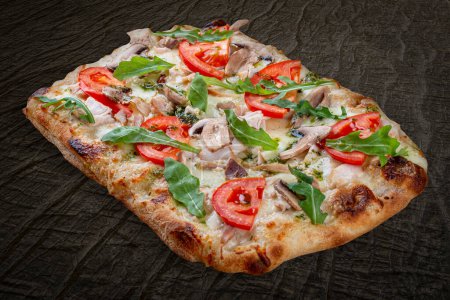 Bianco pizza with smoked chicken, rucola, cheese sauce, mushroom, pesto. Roman pizza rectangular on wood background