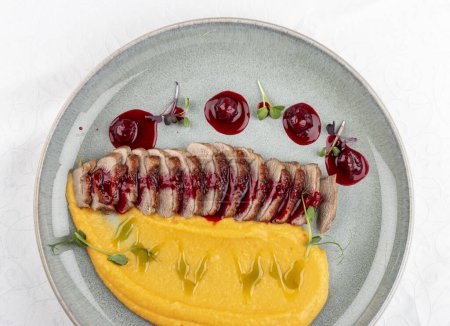 Photo for Duck breast, with pumpkin puree, cherry sauce and peanuts. Isolated image - Royalty Free Image
