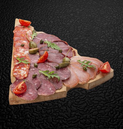 Photo for Board with meat appetizers: basturma, balik, sausage, ham. Isolated image - Royalty Free Image