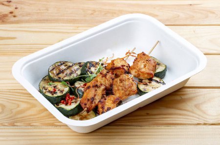 Photo for Grilled chicken kebab with zucchini. Healthy diet. Takeaway food.  On a wooden background. - Royalty Free Image
