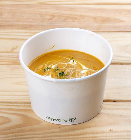 Salmon cream soup. Healthy food. Takeaway food.  On a wooden background.