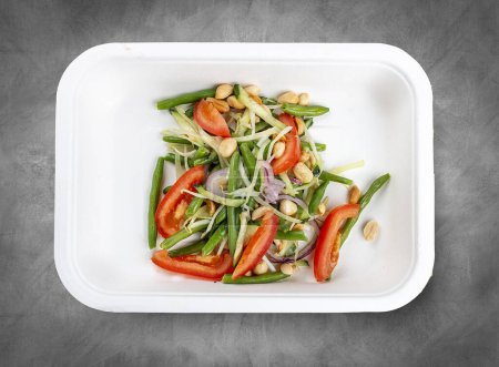 Thai vegetable salad. Vegetarian food. Takeaway food. Top view, on a gray background.