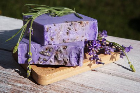 Photo for Lavender soap on a vintage wooden board. - Royalty Free Image