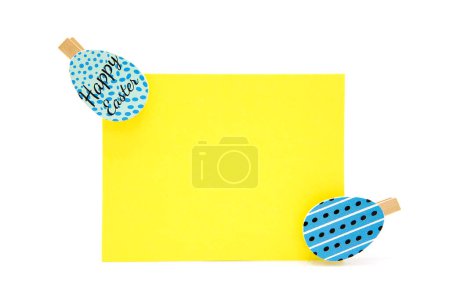 Greeting blank card and clothespins with colored eggs. Copy space. Free space for text. Happy easter! 