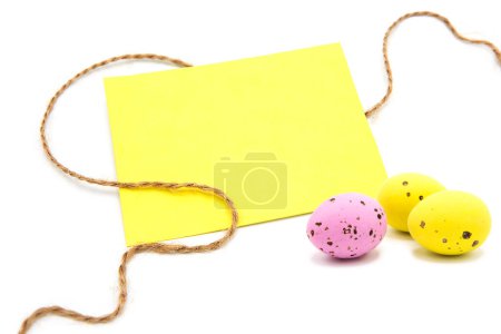 Tarjeta de felicitación en blanco con cuerda con huevos de colores aislados sobre un fondo blanco. Copiar espacio. Espacio libre para texto. Feliz Pascua.!