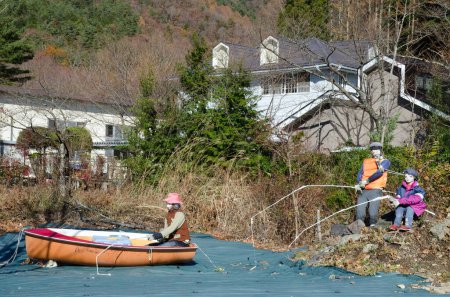 Photo for Human figures representing fishermen in a lake. Saiko. Fujikawaguchiko. Yamanashi Prefecture. Fuji-Hakone-Izu National Park. Honshu. Japan. - Royalty Free Image