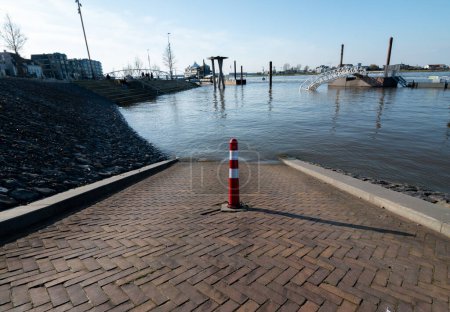 Photo for Nijmegen, The Netherlands 4 April 2023: The river the waal is flooding because of global warming, the road is going into the water - Royalty Free Image