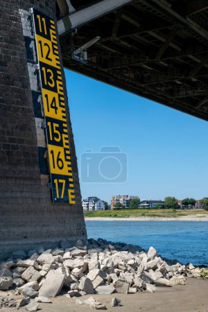 Photo for Water level is below the level of the nap water indicator because of global warming, at the waalbridge over the river Waal in Nijmegen, the Netherlands - Royalty Free Image