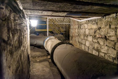 Big pipes of coal mine ventilation system in underground tunnel