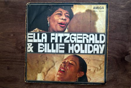 Photo for Lublin, Poland. 18 January 2023. Ella Fitzgerald and Billie Holiday vinyl album cover on dark wooden table. - Royalty Free Image