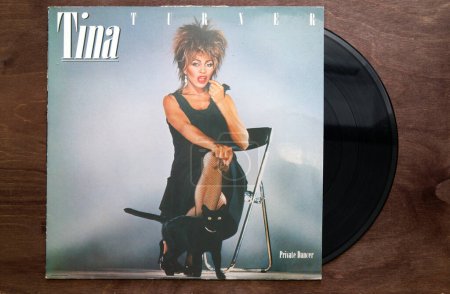 Foto de Lublin, Poland. 18 January 2023. Tina Turner "Private Dancer" vinyl album cover on dark wooden table - Imagen libre de derechos