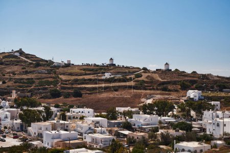 Photo for Panoramic Aerial View from Emporio Village with Windmills on a Hill in Santorini Island, Greece - Traditional White Houses in the Caldera Cliffs - Royalty Free Image