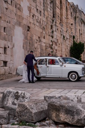 Photo for Bride and Groom in a Beautiful Old Car - Wedding in Split, Croatia - Royalty Free Image