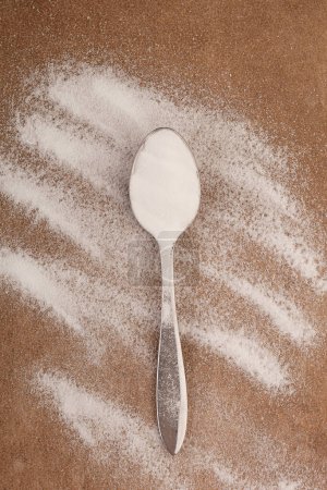 Photo for Baking soda powder on spoon from above. - Royalty Free Image
