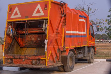 Photo for Industrial garbage truck with hydraulic under blue sky. Rear and side view. Nobody. garbage truck in Thailand. - Royalty Free Image