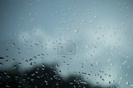 Photo for Raindrops on glass walls on cars, rain drops on clear windows or rain droplets on glass of raindrops or vapors of windows - Royalty Free Image