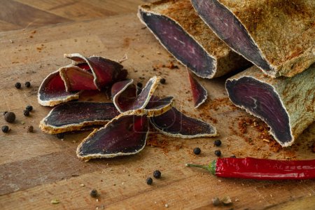 Photo for Dried beef basturma sliced on a cutting board - Royalty Free Image