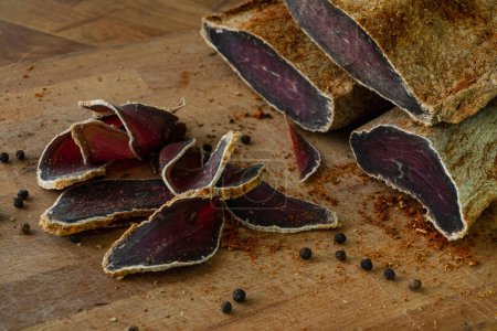 Photo for Dried beef basturma sliced on a cutting board - Royalty Free Image