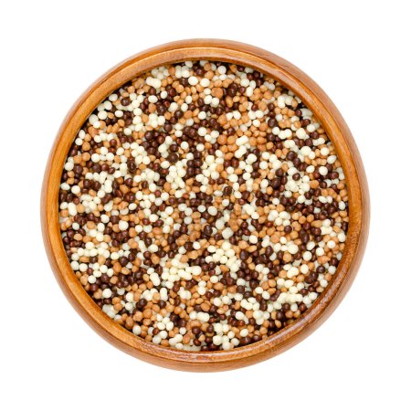 Photo for Mini chocolate crispy pearls mix, in a wooden bowl. Sweet crunchy cereal extrudate with a coating of dark, milk and white chocolate. Used as decoration for cookies, pralines, and cakes, or as a snack. - Royalty Free Image