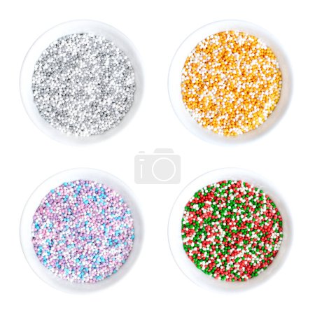 Photo for Colored nonpareils in white bowls. Four colored mixes of decorative and edible confectionery of tiny balls, made with sugar and starch. Hundreds and Thousands, used as sweet decoration and as topping. - Royalty Free Image
