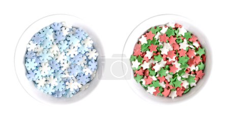 Photo for Snowflake and star shaped confetti sprinkles, in white bowls. Confetti candy, confectionery product, made of sugar and rice, consisting of flat multicolored candy sprinkles, used as edible decoration. - Royalty Free Image