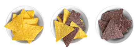 Photo for Yellow, mixed and blue tortilla chips, in white bowls. Snack food, made from corn tortillas, cut into triangle shaped wedges, fried in oil and slightly salted. Close-up, from above, isolated, photo. - Royalty Free Image