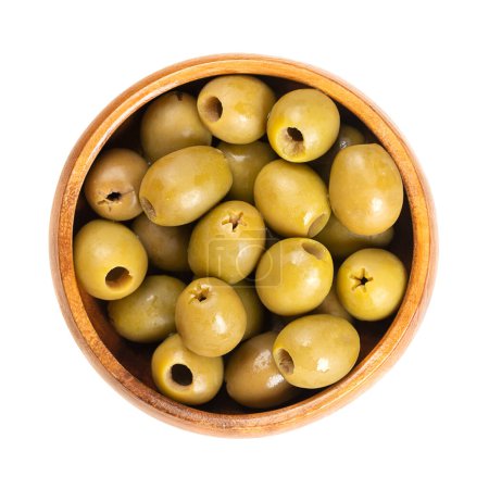 Photo for Pitted green olives, in a wooden bowl. Organic olives from Italy. Picked as semi-ripe and turning-color olives, with reddish-green color, preserved in salt. Used as a snack, appetizer or as garnish. - Royalty Free Image