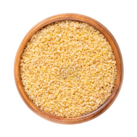 Coarse bulgur, also called burghul, in a wooden bowl. Cracked and parboiled wheat foodstuff, and a common ingredient in many cuisines of West Asia and Mediterranean Basin, with light and nutty flavor.