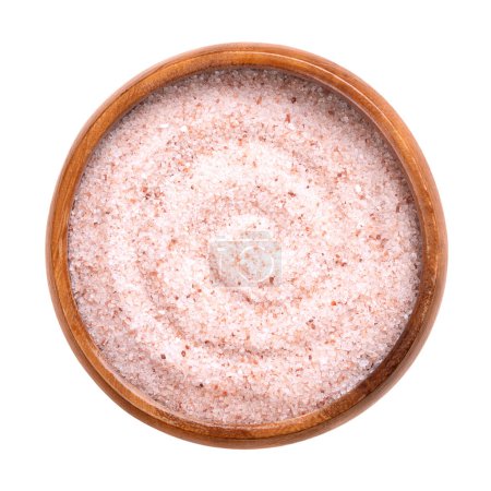 Foto de Himalaya sal rosa fina, en un tazón de madera. Sal fina del Himalaya, sal de roca y halita con un tinte rosado, debido a los minerales traza, extraídos de la región de Punjab, utilizados como aditivo alimentario para reemplazar la sal de mesa. - Imagen libre de derechos