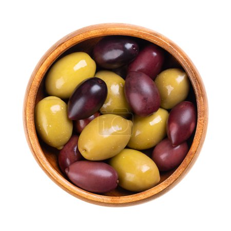 Photo for Kalamata and green olives with pit, pickled whole, large Greek table olives, in a wooden bowl. Purple fruits picked when ripe, and green olives picked while still unripe, both preserved in brine. - Royalty Free Image