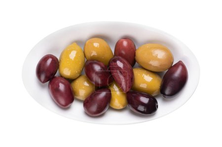 Photo for Kalamata and green olives with pit, pickled whole, large Greek table olives, in a white oval bowl. Purple fruits picked when ripe, and green olives picked while still unripe, both preserved in brine. - Royalty Free Image