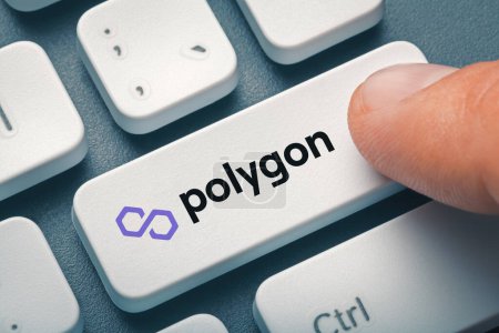 Male finger pressing computer key with polygon token logo. Cryptocurrrency exchange or trading concept.