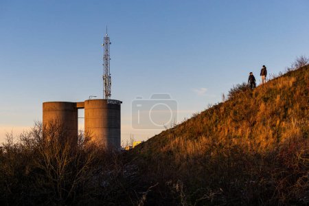 Photo for Copenhagen, Denmark, Teenagers play on a small hill in the Amager dustrict. - Royalty Free Image