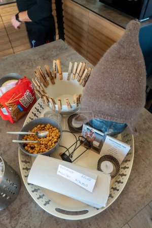 Téléchargez les photos : Copenhagen, Denmark A tray with peanuts, clothes pins, salted sticks and a sauna gus hat, all items for sale at a suana facility. - en image libre de droit